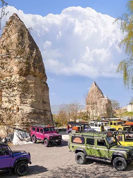 Jeep convoy parked near rock formations in Cappadocia during guided off-road tour.
