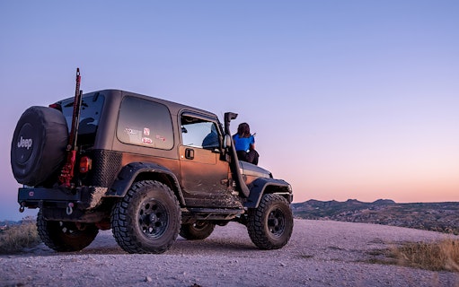 Guided off-road Jeep tour in Cappadocia at sunset with scenic views.