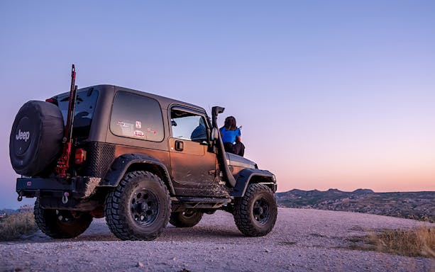 Guided off-road Jeep tour in Cappadocia at sunset with scenic views.