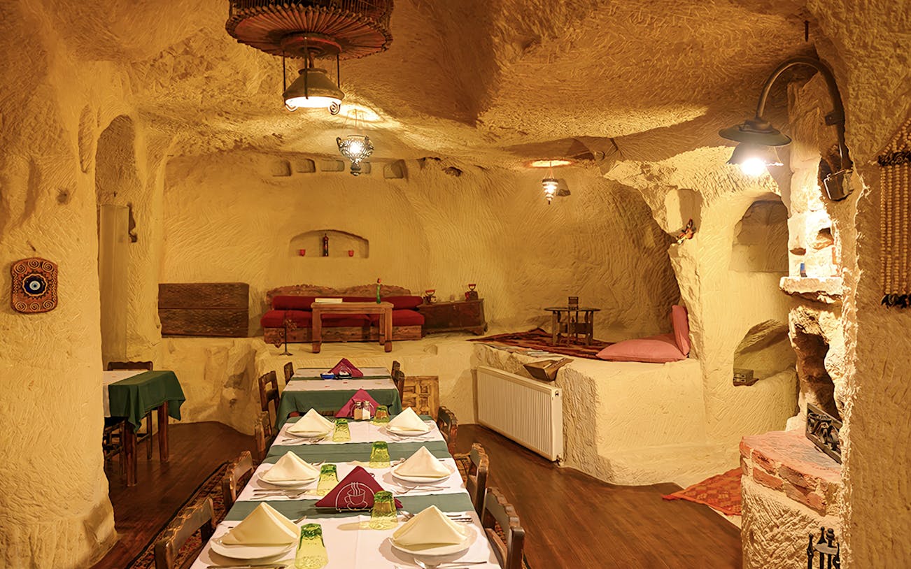 Cave restaurant interior in Cappadocia set for Turkish Night event.
