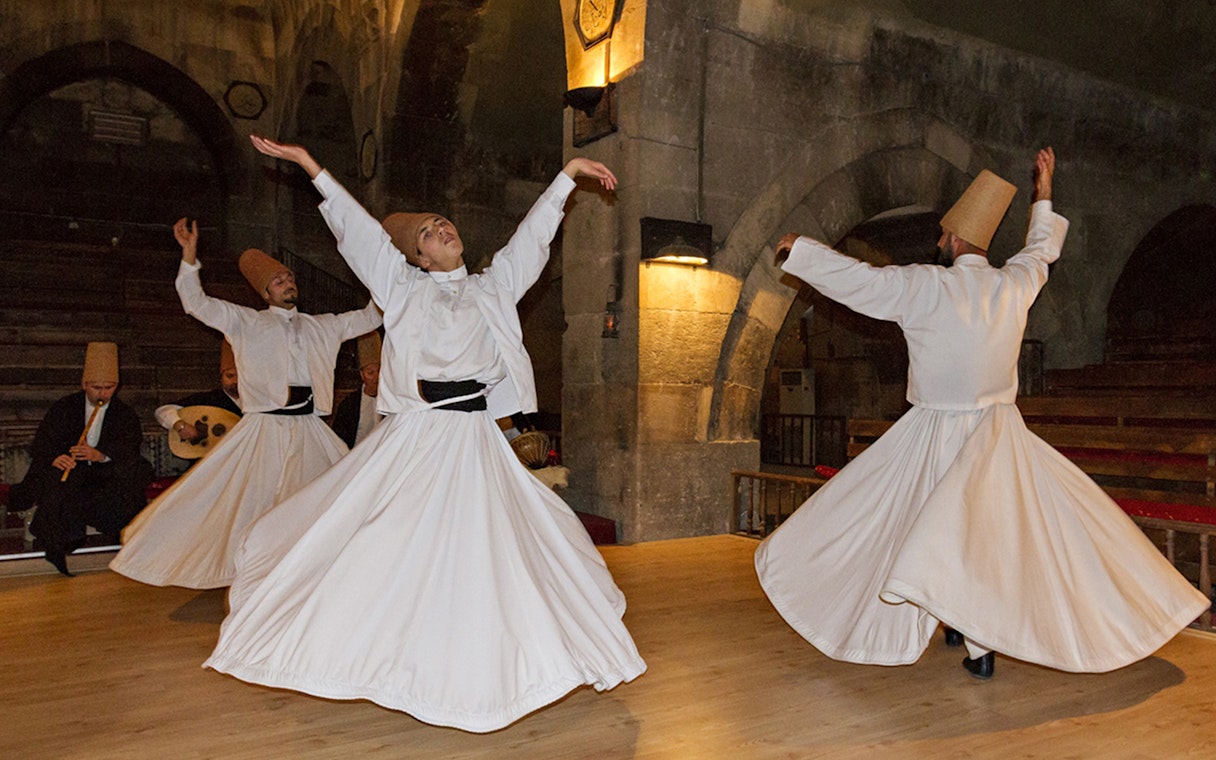 Whirling Dervishes performing in a traditional setting in Cappadocia.