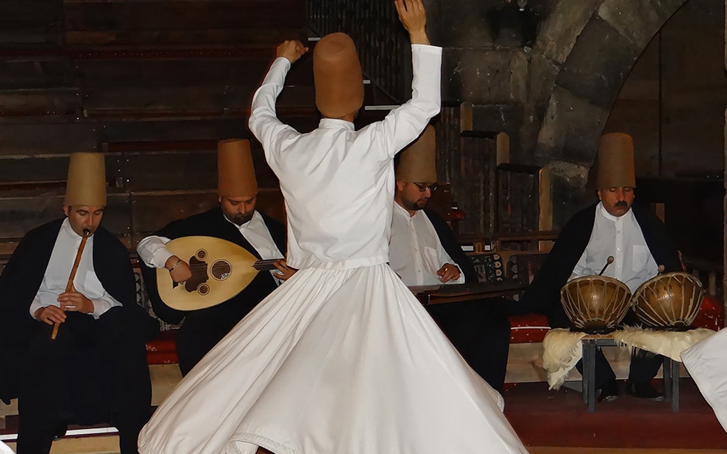 Whirling Dervish performing with musicians in Cappadocia.