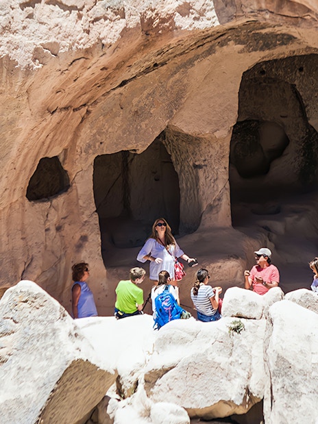 Tour group exploring cave dwellings in Cappadocia during private tour.