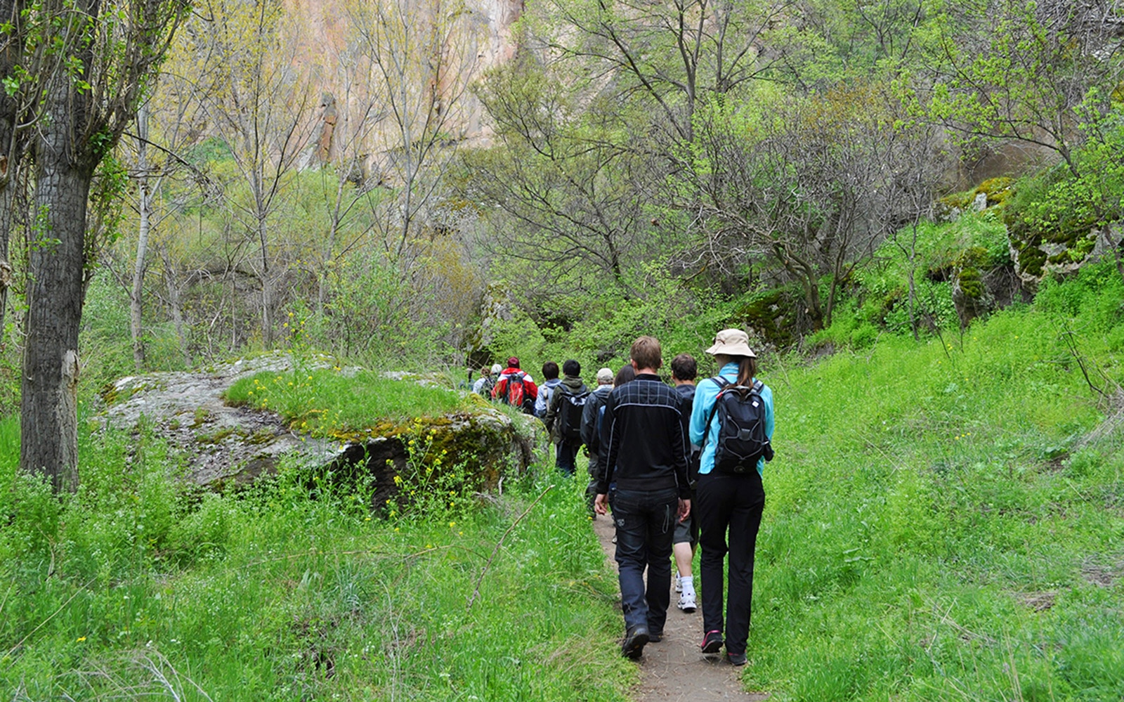 Group trekking through lush Ihlara Valley on Cappadocia Green Tour.