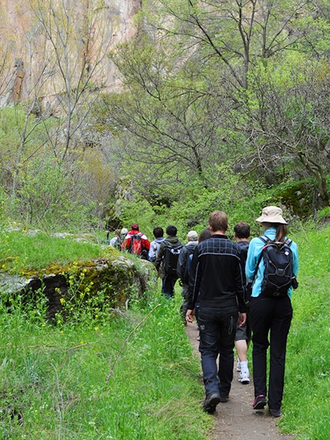 Group trekking through lush Ihlara Valley on Cappadocia Green Tour.