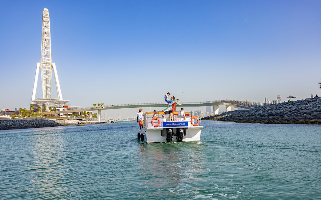 Boat on Dubai waterway near Ain Dubai during Atlantis Scenic Cruise.