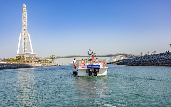Boat on Dubai waterway near Ain Dubai during Atlantis Scenic Cruise.