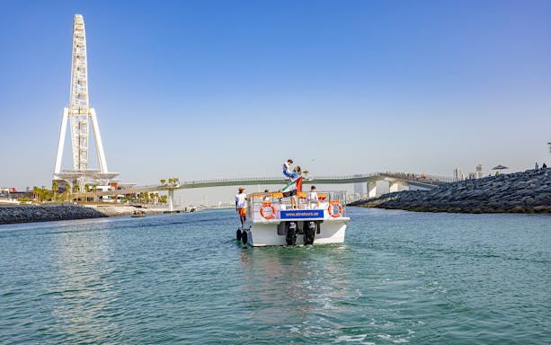 Boat on Dubai waterway near Ain Dubai during Atlantis Scenic Cruise.