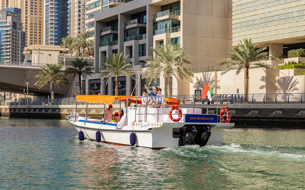 Dubai Marina cruise boat with tourists enjoying the Atlantis Scenic Cruise.