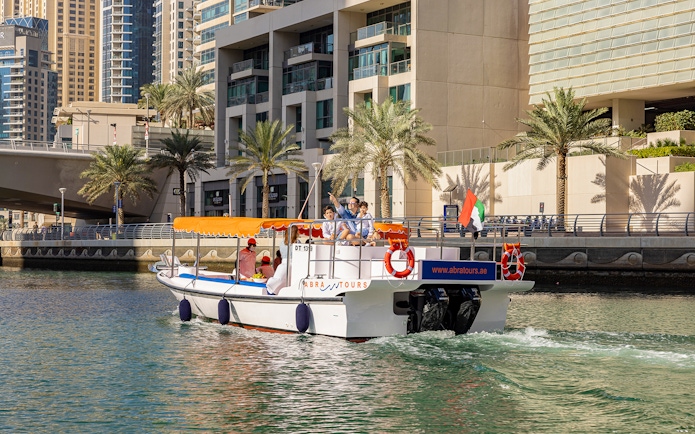 Dubai Marina cruise boat with tourists enjoying the Atlantis Scenic Cruise.