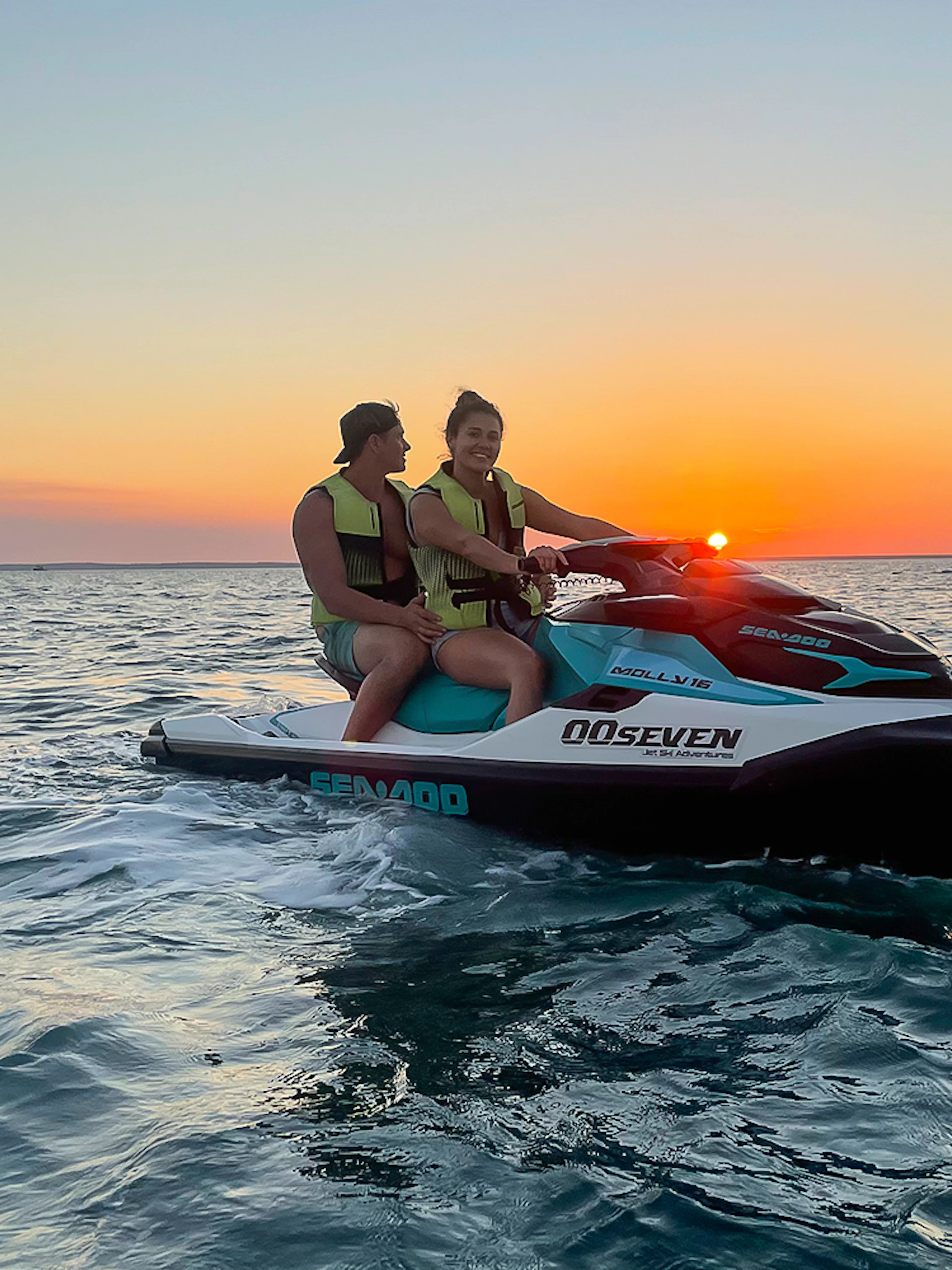 Two people on a jet ski during sunset on a Darwin tour.