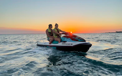 Two people on a jet ski during sunset on a Darwin tour.