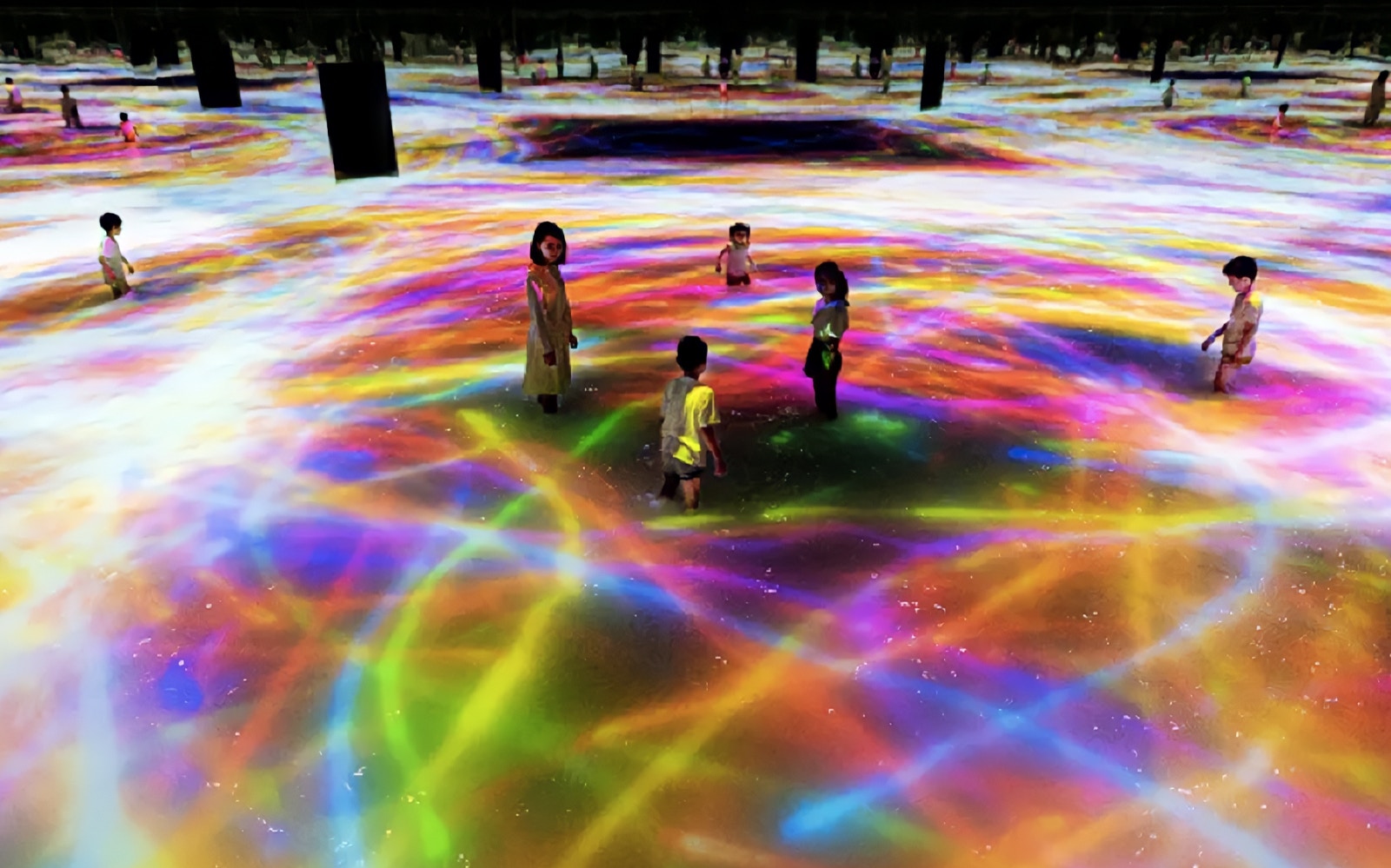 Visitors exploring immersive digital art installation at TeamLab Planets Tokyo.