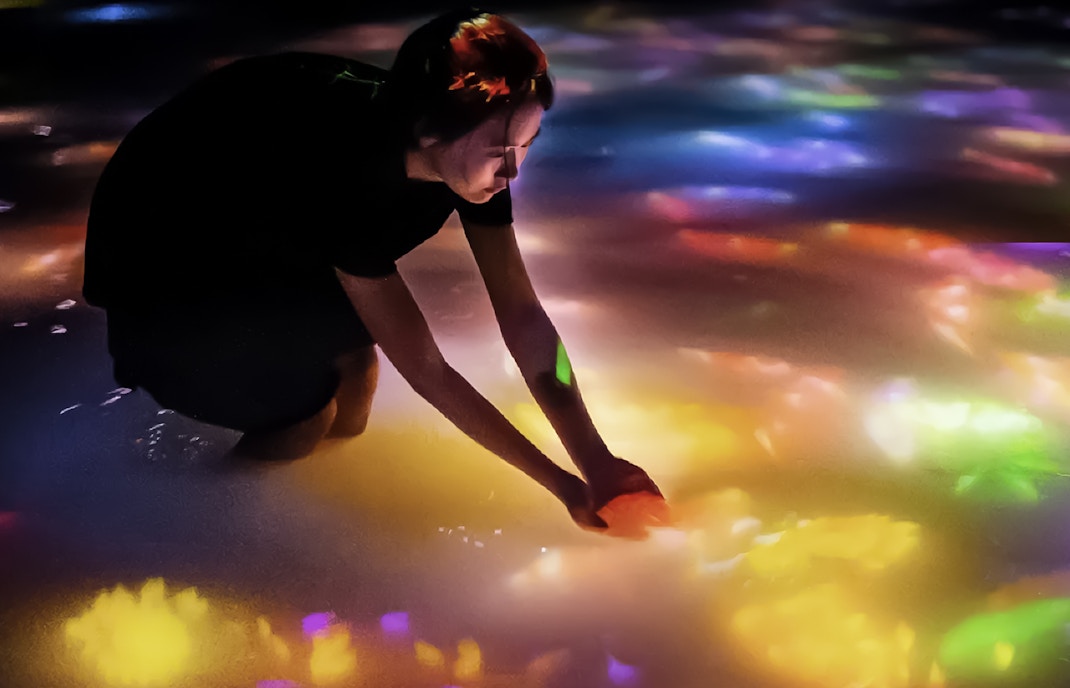 Visitors exploring immersive digital art installation at TeamLab Planets Tokyo.