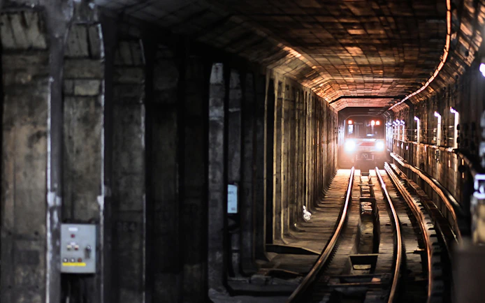 Subway train approaching in a Tokyo underground tunnel.