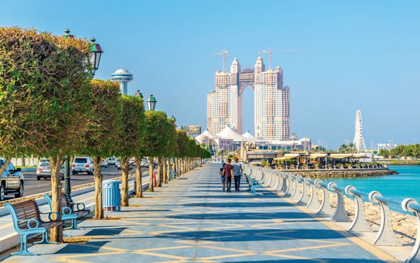 Abu Dhabi Corniche with skyline and waterfront promenade.