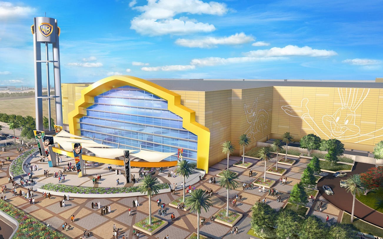 Warner Bros World Abu Dhabi entrance with iconic character murals and visitors.