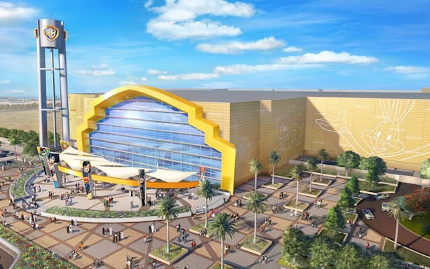 Warner Bros World Abu Dhabi entrance with iconic character murals and visitors.