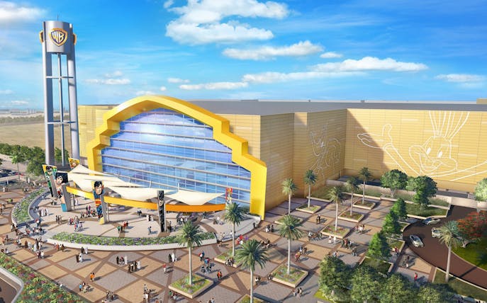 Warner Bros World Abu Dhabi entrance with iconic character murals and visitors.