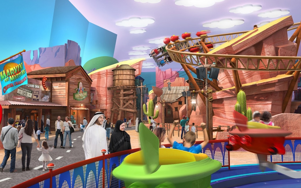 Warner Bros World Abu Dhabi theme park with families enjoying rides and attractions.