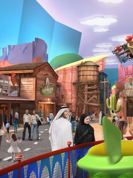 Warner Bros World Abu Dhabi theme park with families enjoying rides and attractions.