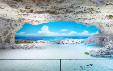 Rocky cave with view of ocean and sky at DMM Kariyushi Aquarium.