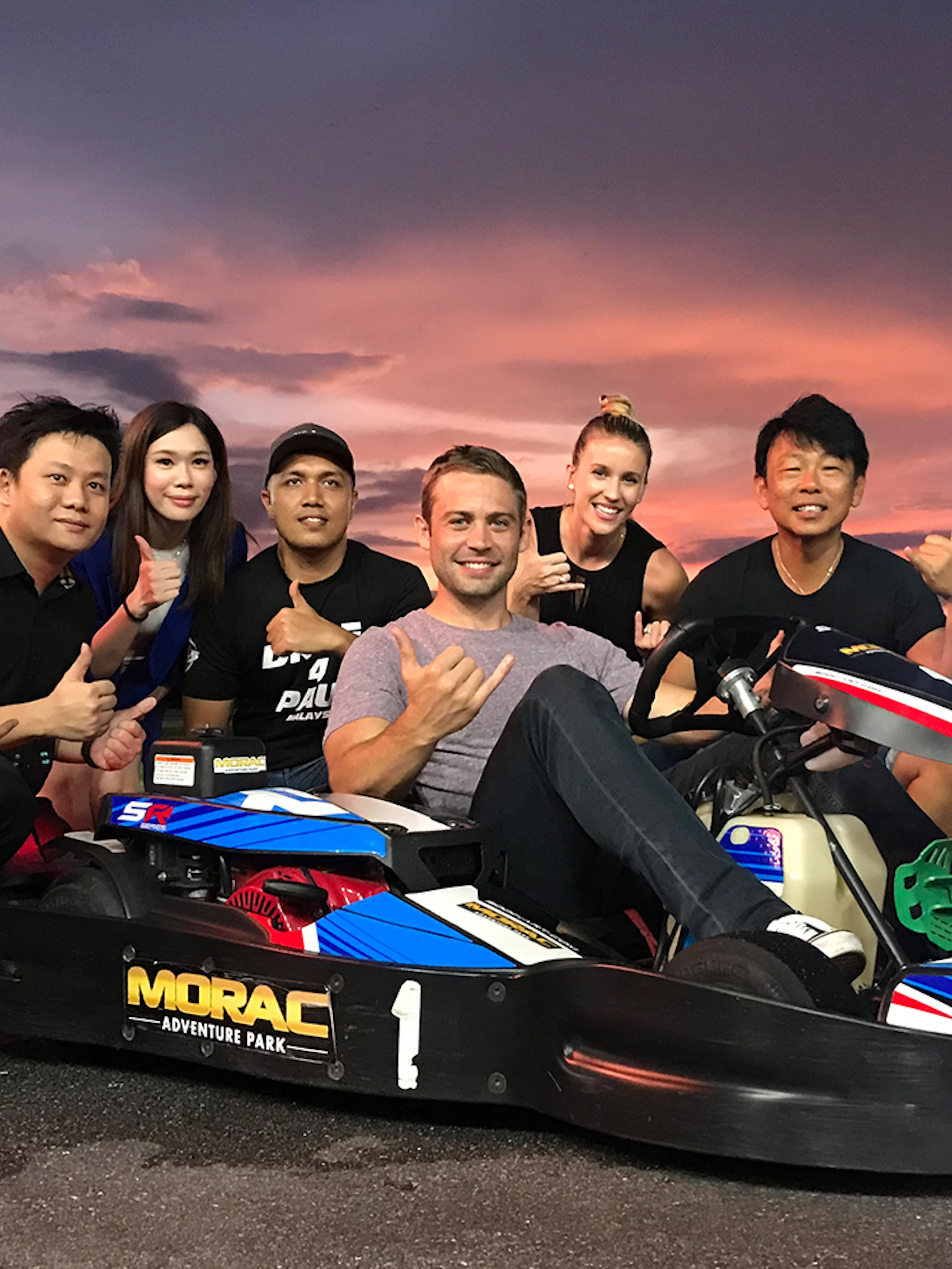 Group enjoying go-karting at Morac Adventure Park, Langkawi, during sunset.