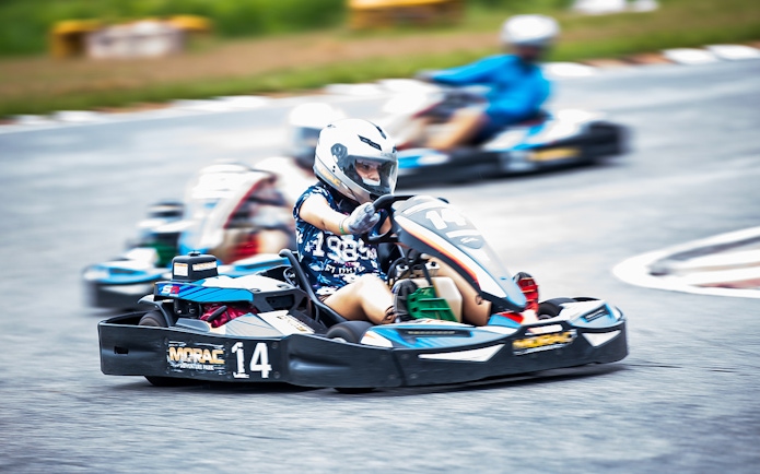 Go-kart racing at Morac Adventure Park, Langkawi, with drivers navigating the track.