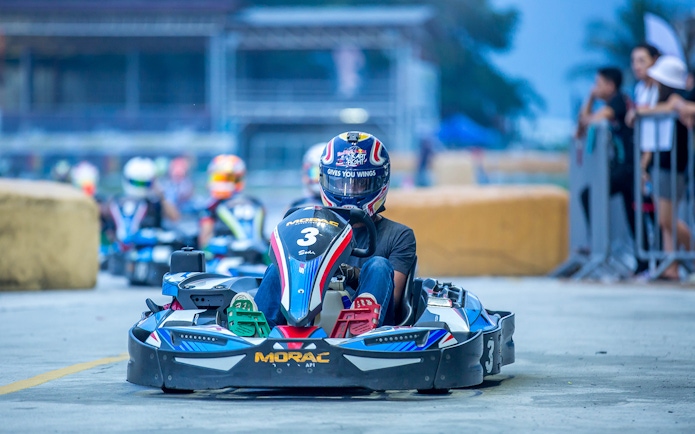 Go-kart racing at Morac Adventure Park, Langkawi, with driver on track.