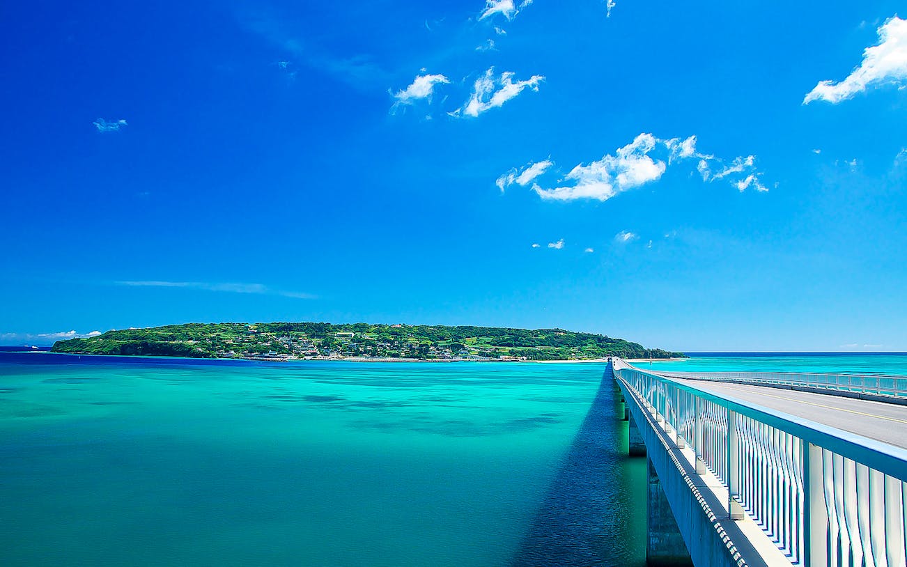 Okinawa bridge over turquoise water on sightseeing bus tour route.