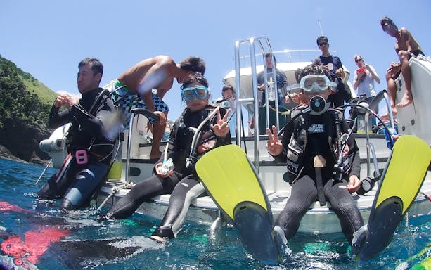 Snorkelers preparing to dive from a boat at Kerama Islands.