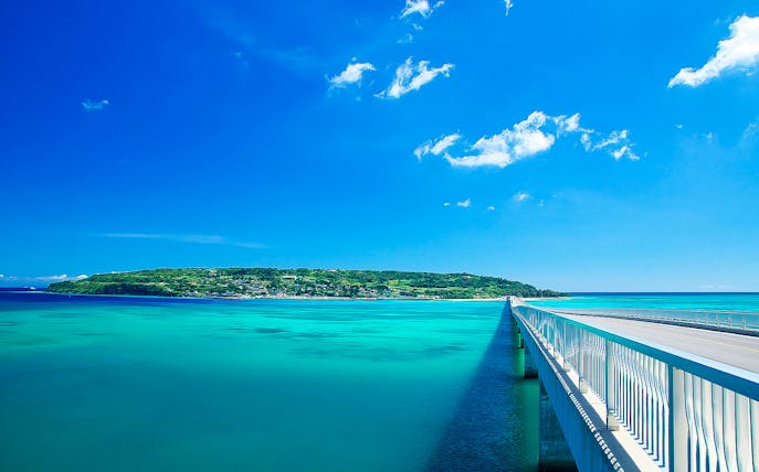 Bridge over turquoise waters leading to Okinawa island, Japan, on a clear day.