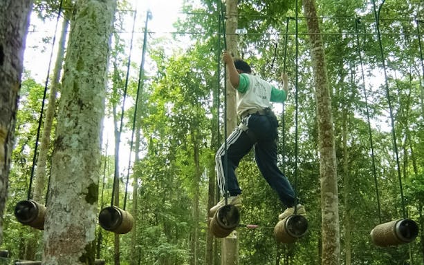 Person navigating rope course at Skytrex Adventure Melaka.