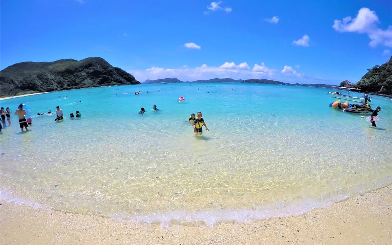 Visitors enjoying the clear waters at Tokashiku Beach during a seabathing tour.
