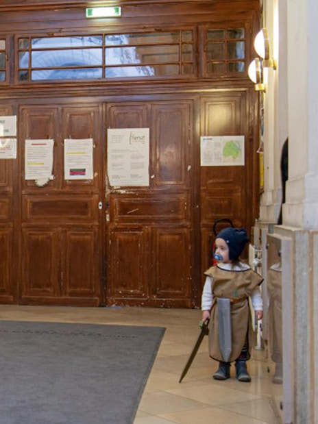 Character in costume and child in hallway at Jewish Museum Vienna.