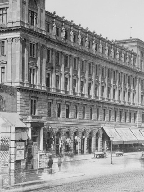 Historic street view near Jewish Museum Vienna with Votivkirche in the background.