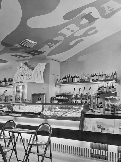 Bar area with chairs and neon sign at Jewish Museum Vienna.