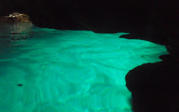 Blue Cave illuminated waters during scuba diving tour.