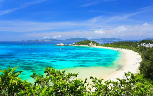 Tokashi Island beach with turquoise water and lush greenery on a 1-day tour.