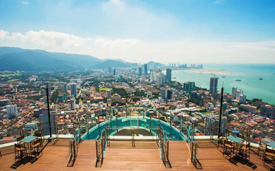 Sky view of Penang cityscape from The Top, overlooking the ocean and urban landscape.