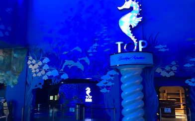 Entrance to The Top Penang with seahorse sign and ocean-themed decor.