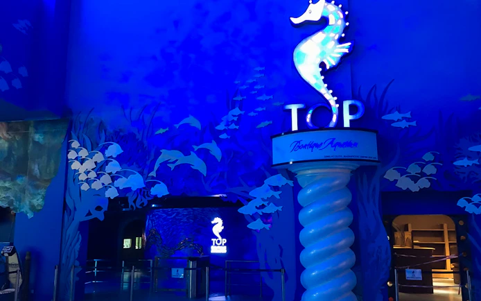 Entrance to The Top Penang with seahorse sign and ocean-themed decor.
