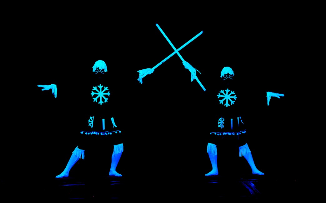 Performers in glowing costumes at WOW Show Black Light Theater.