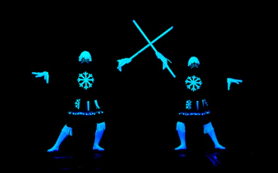 Performers in glowing costumes at WOW Show Black Light Theater.