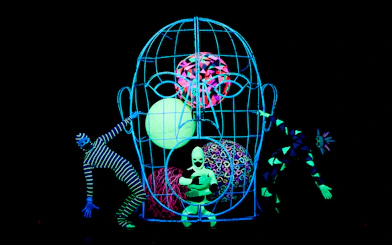 Performers in neon costumes at WOW Show Black Light Theater.
