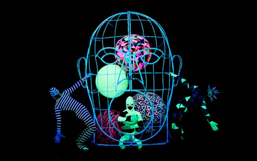 Performers in neon costumes at WOW Show Black Light Theater.