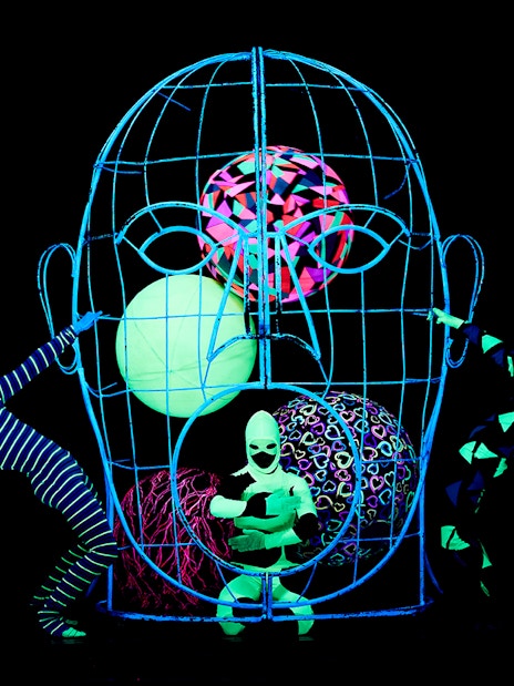 Performers in neon costumes at WOW Show Black Light Theater.