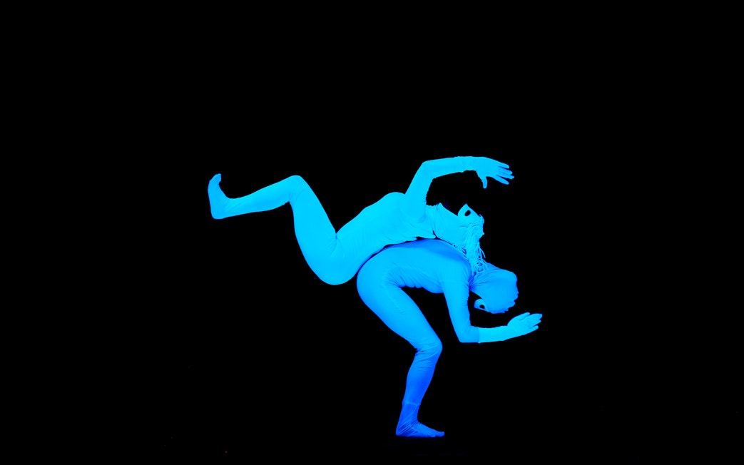 Performers in blue bodysuits at WOW Show Black Light Theater.