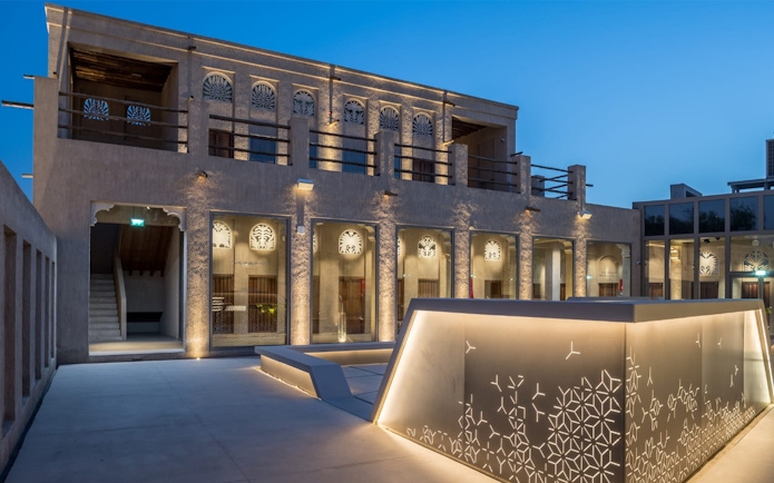 Al Shindagha Museum exterior with illuminated traditional architecture in Dubai.
