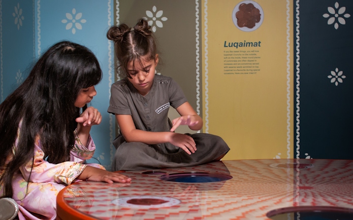 Children exploring interactive exhibit at Al Shindagha Museum.